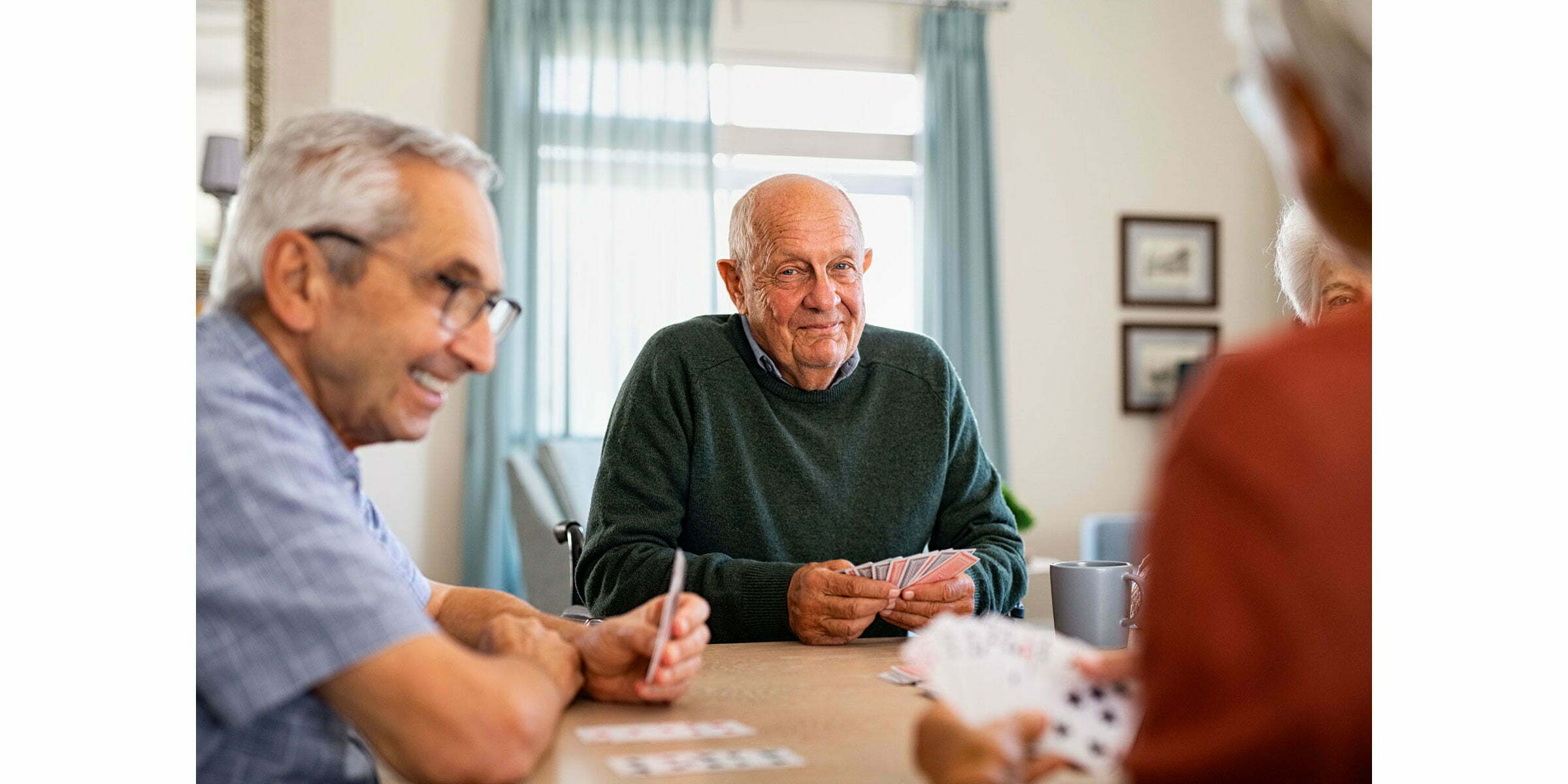 Senior men enjoy a card game together.