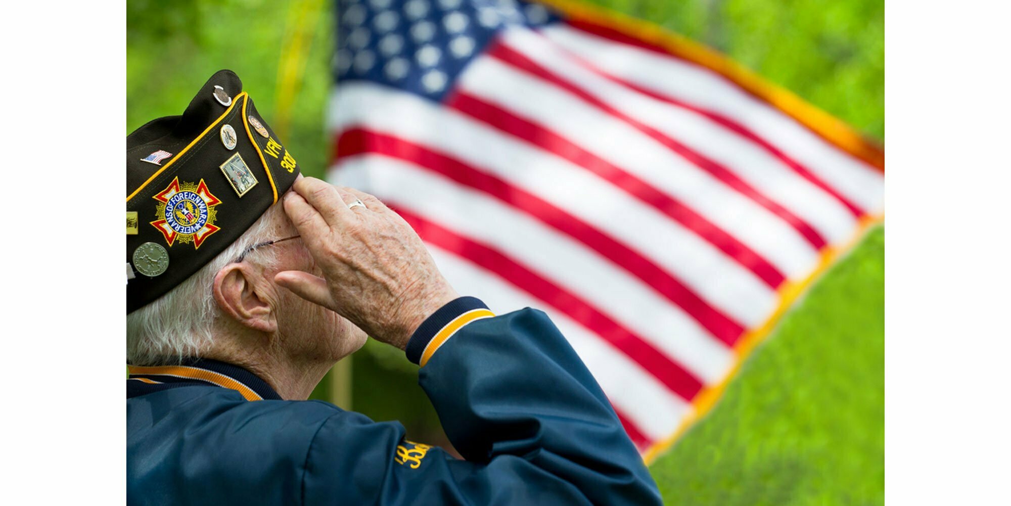 Military Veteran salutes the flag.