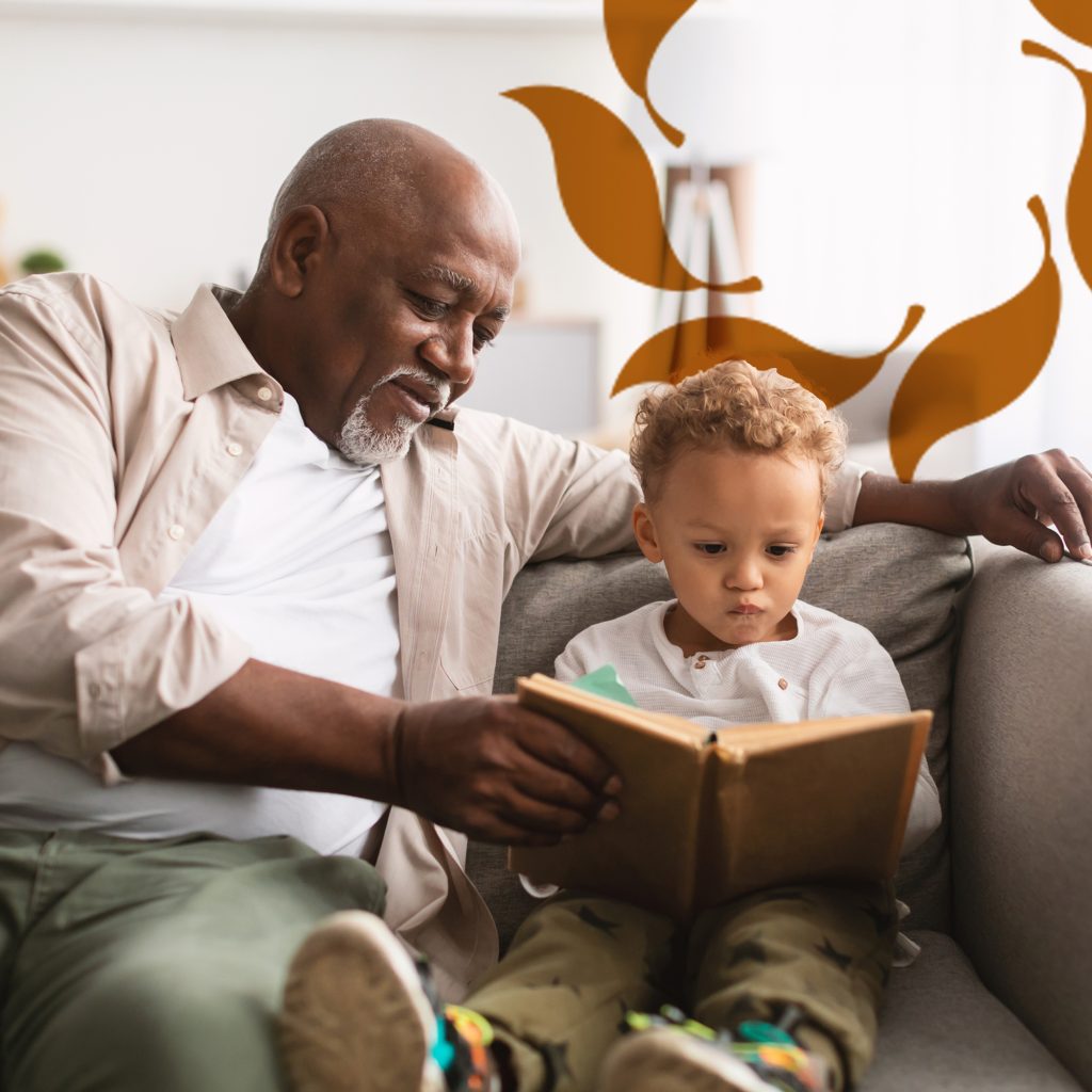 Cappella Pueblo West Senior Living Community in Pueblo West, CO - cappella pueblo west senior man reading with grandson