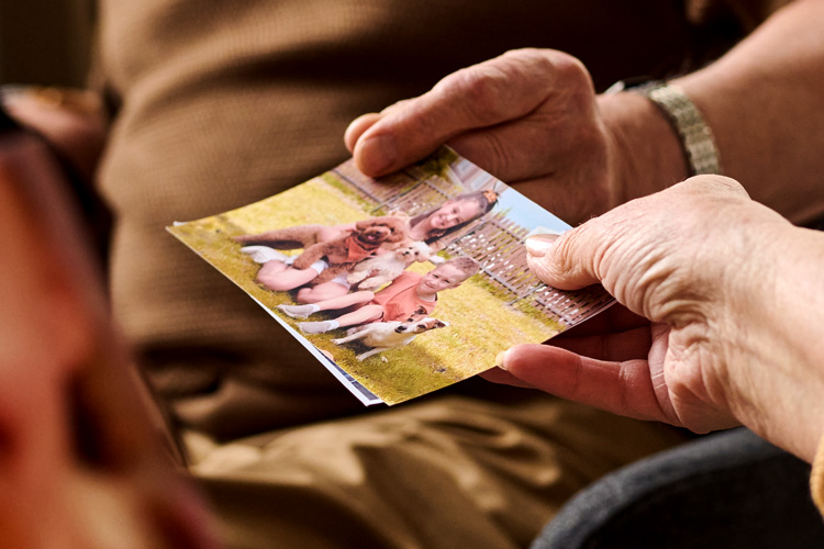 Cappella Pueblo West Senior Living Community in Pueblo West, CO - cappella of pueblo west hands sharing photographs