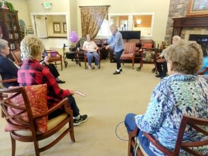 assisted living residents playing balloon badminton 