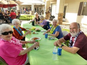 assisted living residents at luau party 