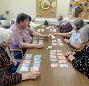 assisted living residents playing cards