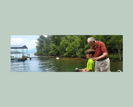 grandfather discussing senior living with son while fishing