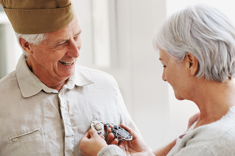 Cappella Pueblo West Senior Living Community in Pueblo West, CO - cappella of pueblo west senior couple woman admiring military award
