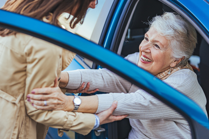 Cappella Pueblo West Senior Living Community in Pueblo West, CO - cappella of pueblo west caregiver helping senior woman out of car