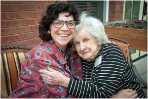 Caretaker hugging resident