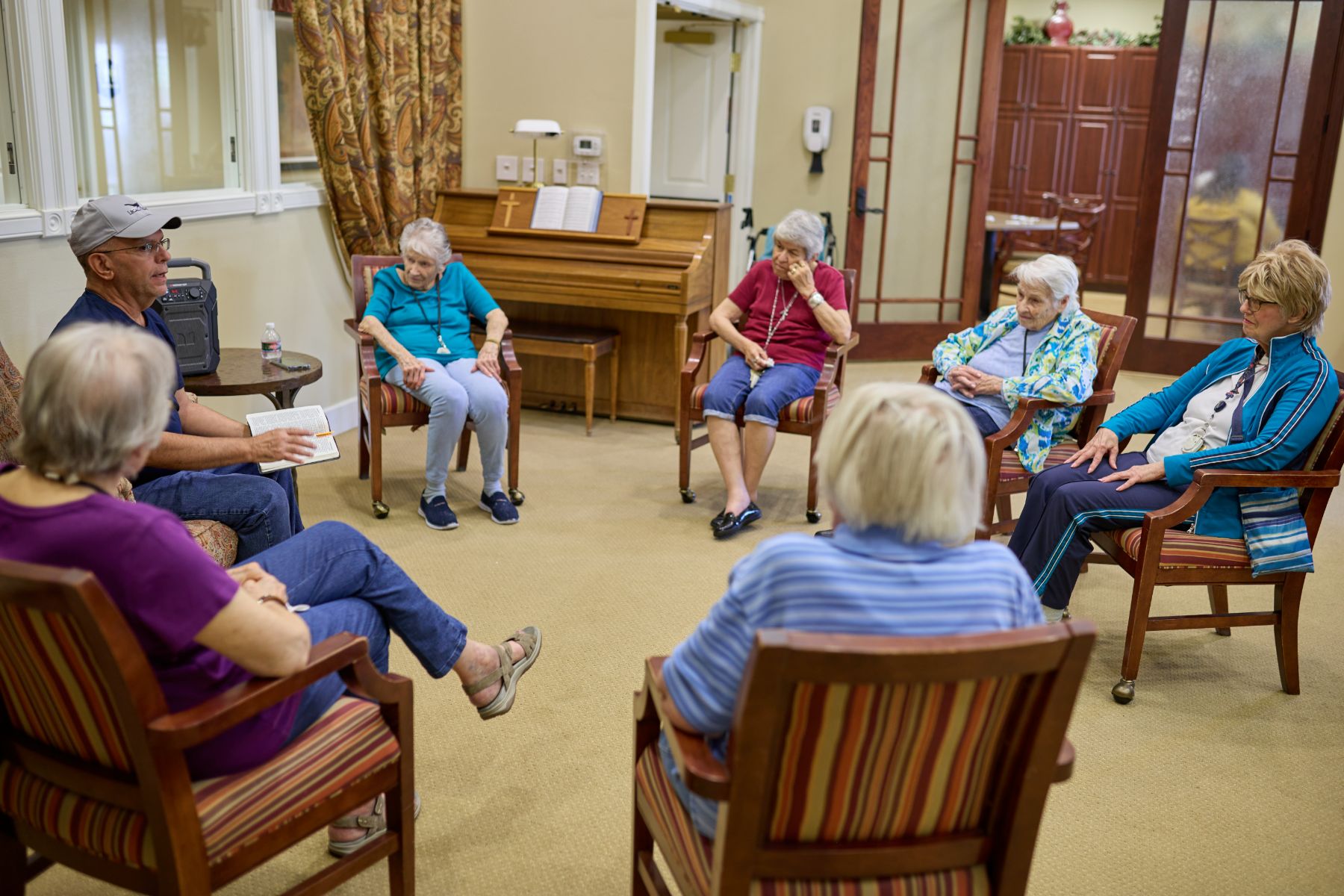 Cappella Pueblo West Senior Living Community in Pueblo West, CO - residents in group discussion