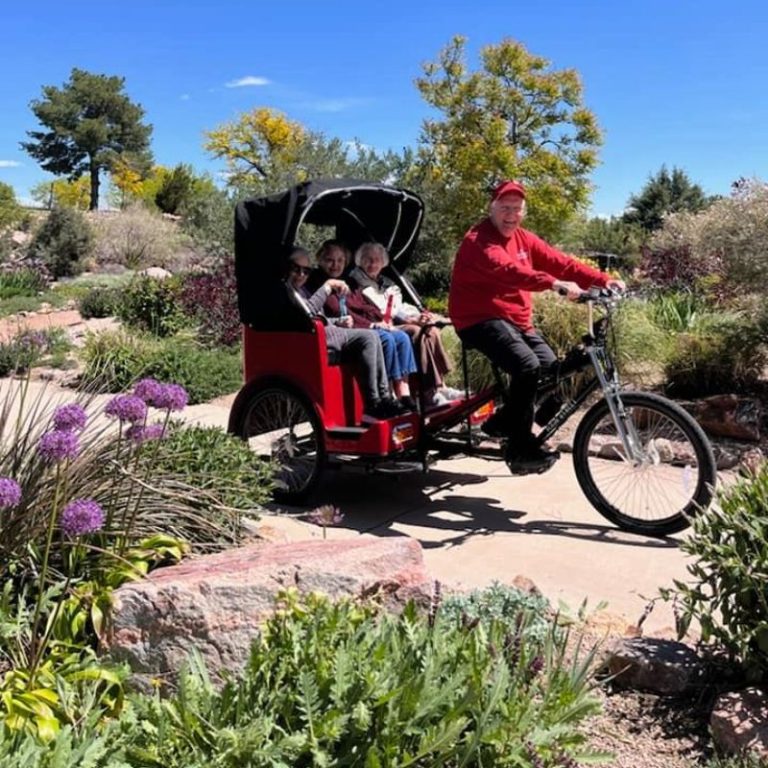 Cappella Pueblo West Senior Living Community in Pueblo West, CO - residents riding on a bike