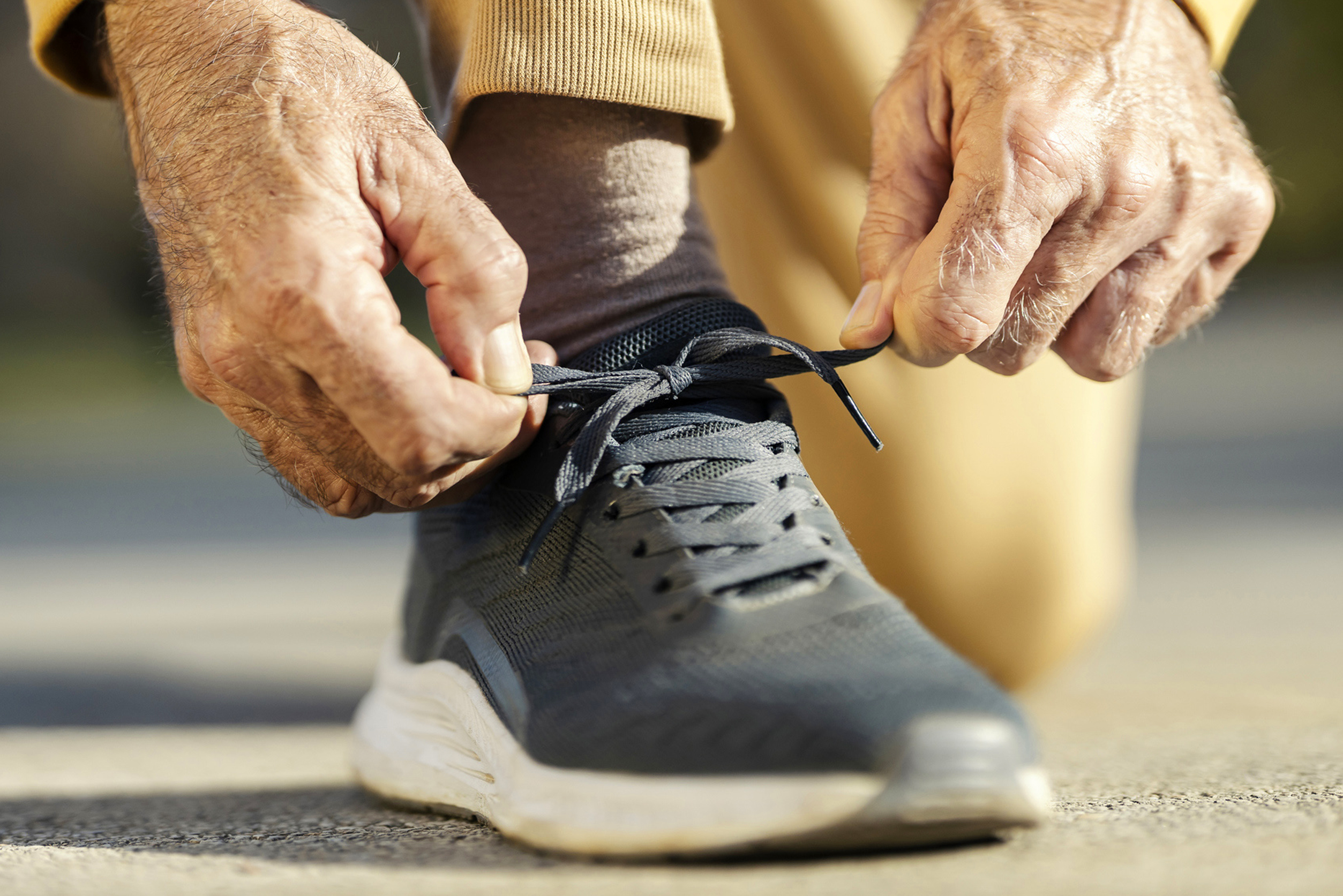 Cappella Pueblo West Senior Living Community in Pueblo West, CO - cappella of pueblo west close up man tying running shoe