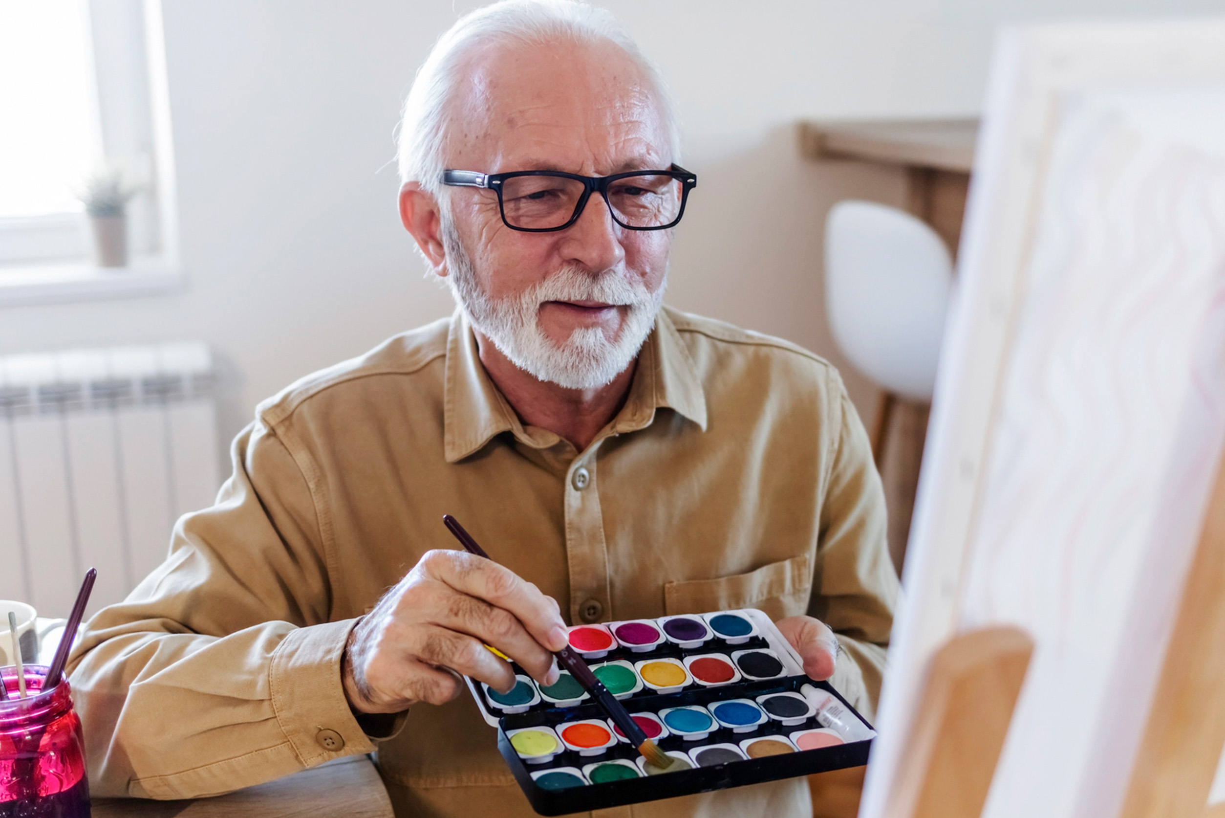 Cappella Pueblo West Senior Living Community in Pueblo West, CO - cappella of pueblo west senior man painting artwork