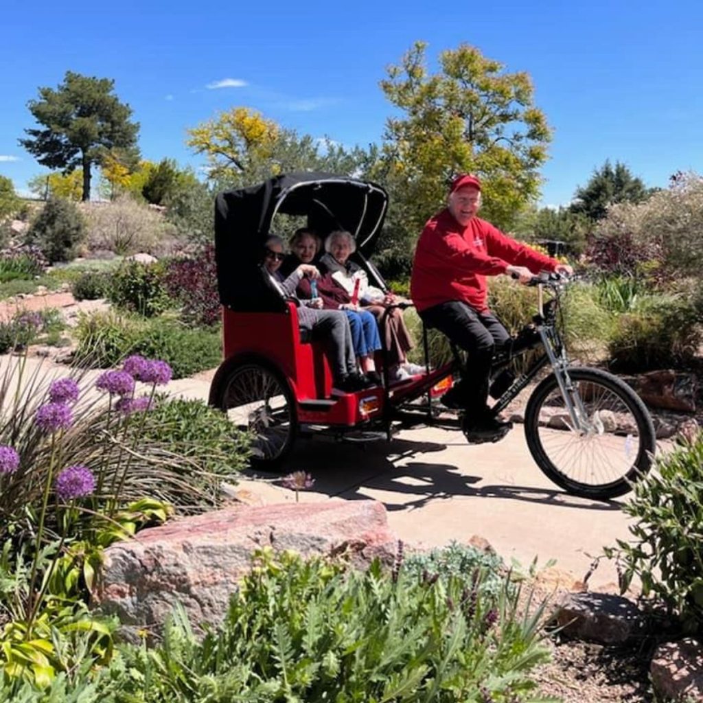 Cappella Pueblo West Senior Living Community in Pueblo West, CO - resdients riding on a bike (1)