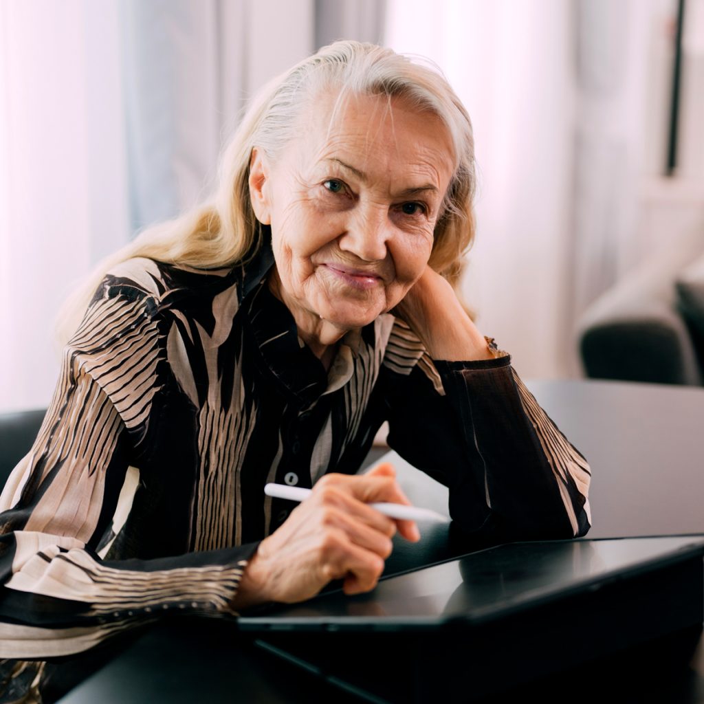 Cappella Pueblo West Senior Living Community in Pueblo West, CO - senior woman using tablet and stylus