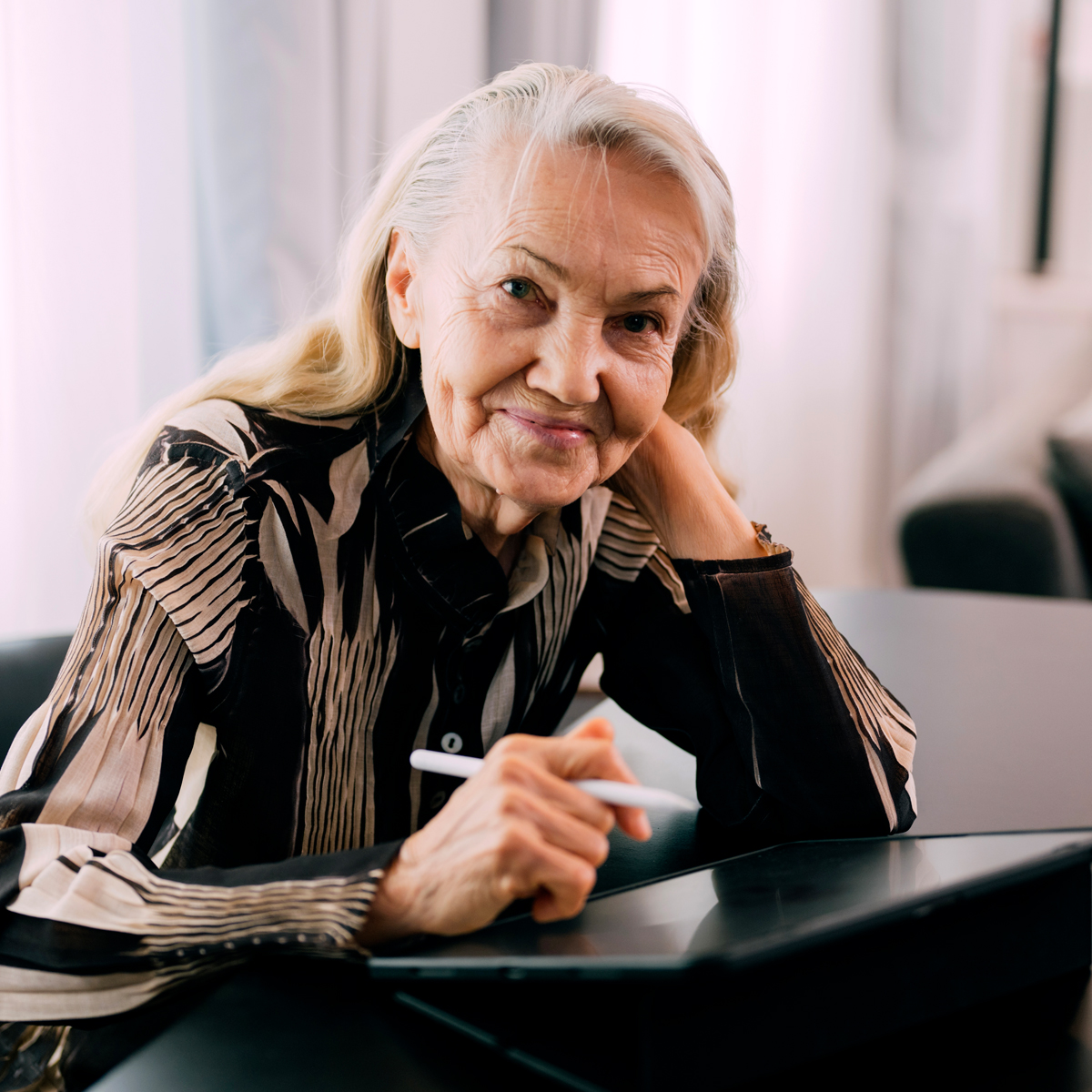 Cappella Pueblo West Senior Living Community in Pueblo West, CO - senior woman using tablet and stylus