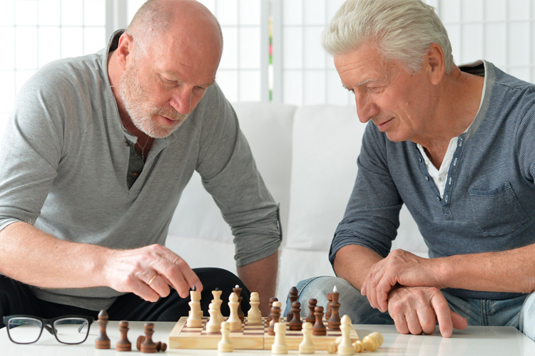 Cappella Pueblo West Senior Living Community in Pueblo West, CO - senior men playing chess Cappella Pueblo West Senior Living Community in Pueblo West, CO - senior men playing chess
