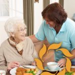 Cappella Pueblo West Senior Living Community in Pueblo West, CO - cappella of pueblo west senior woman with caregiver at lunchtime (2)