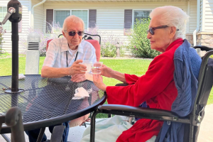 Cappella Pueblo West Senior Living Community in Pueblo West, CO - couple having a drink large landscape